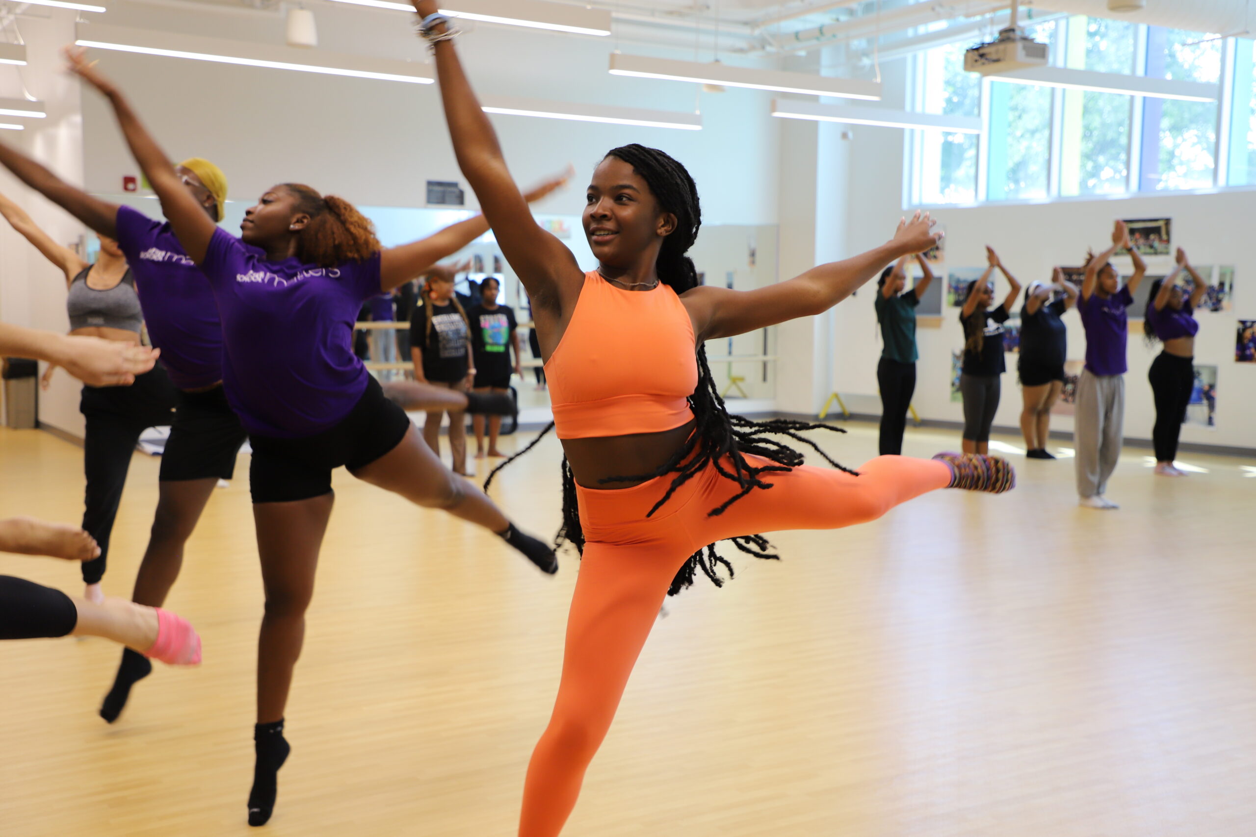 A group of people taking dance class.